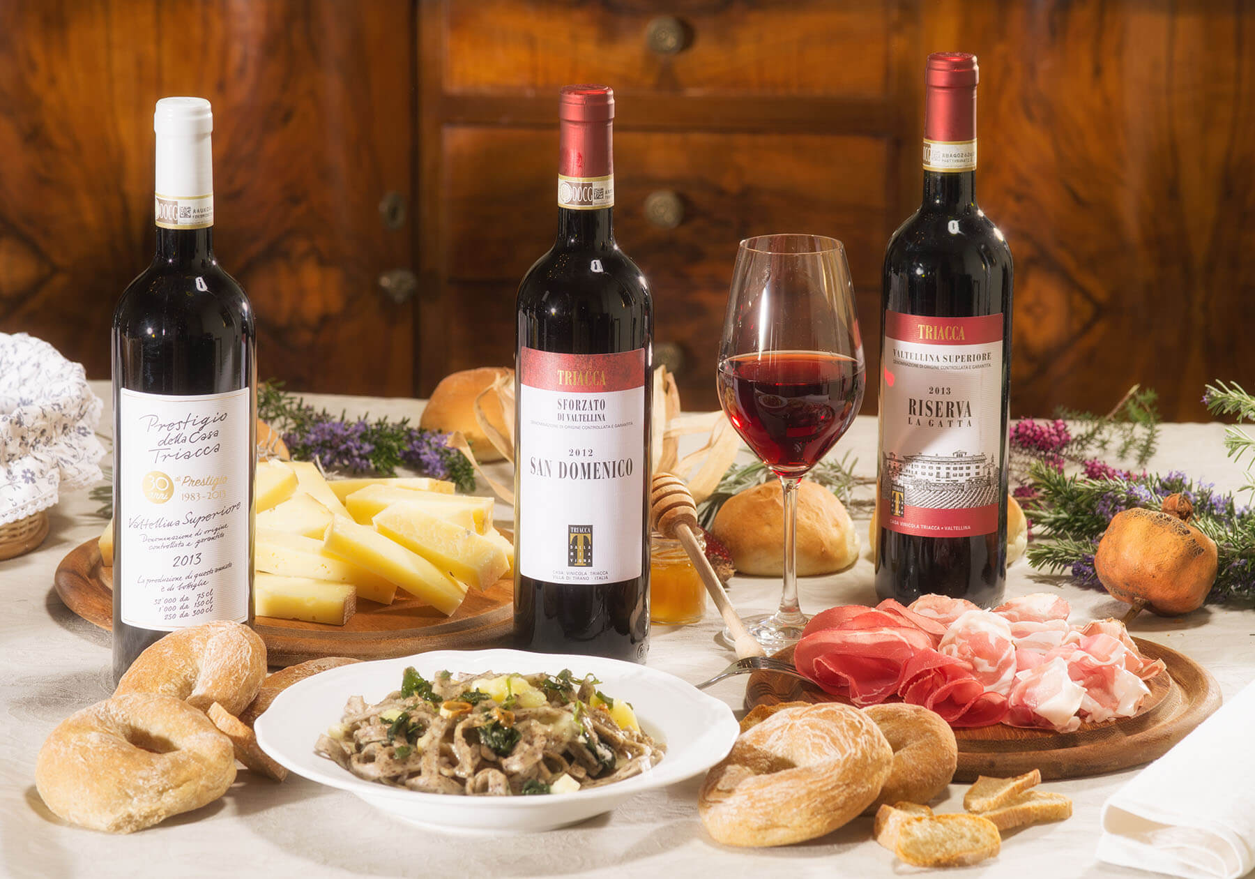 Local Valtellina products and trio of Triacca red wines